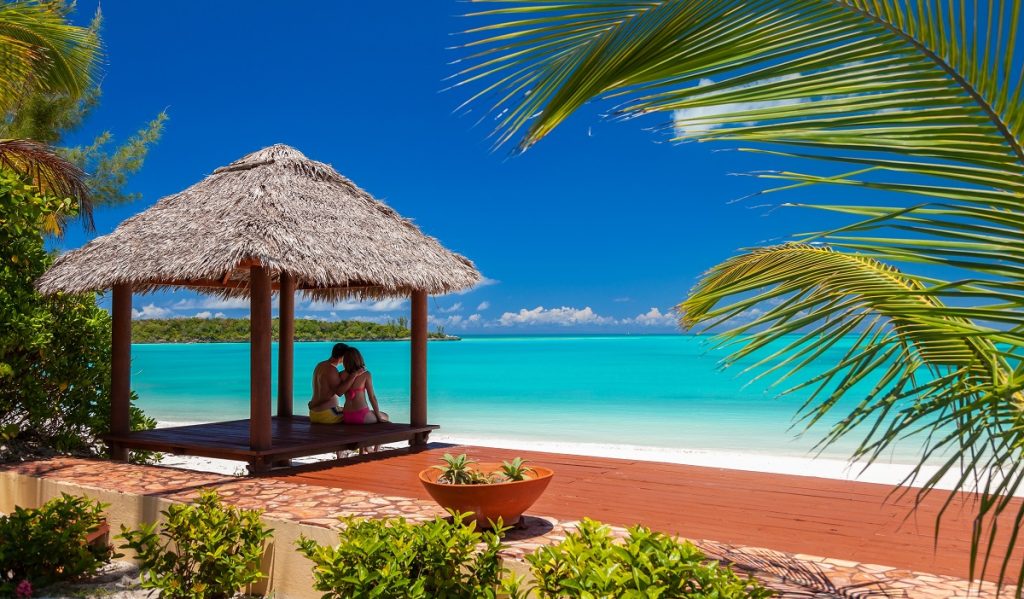 loving,caucasian,male,and,female,couple,in,tropical,bamboo,house