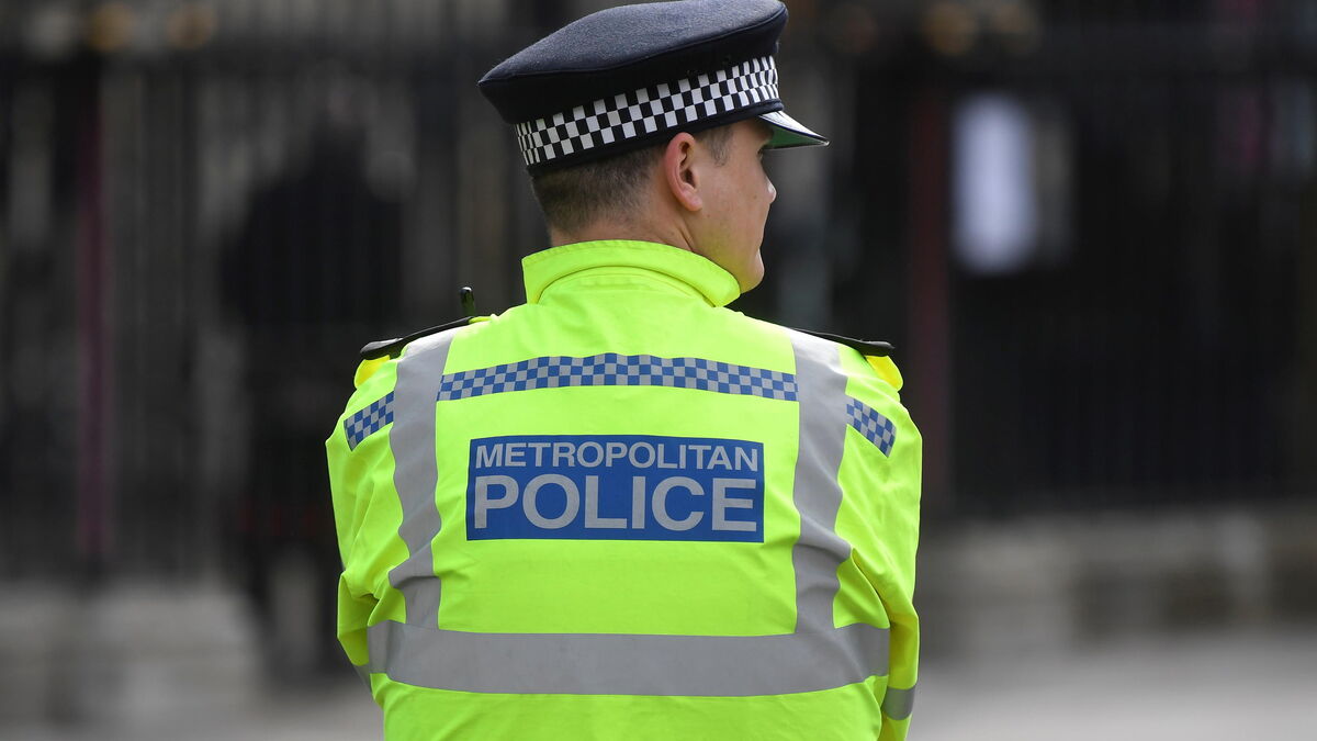 a metropolitan police officer stands on duty in london